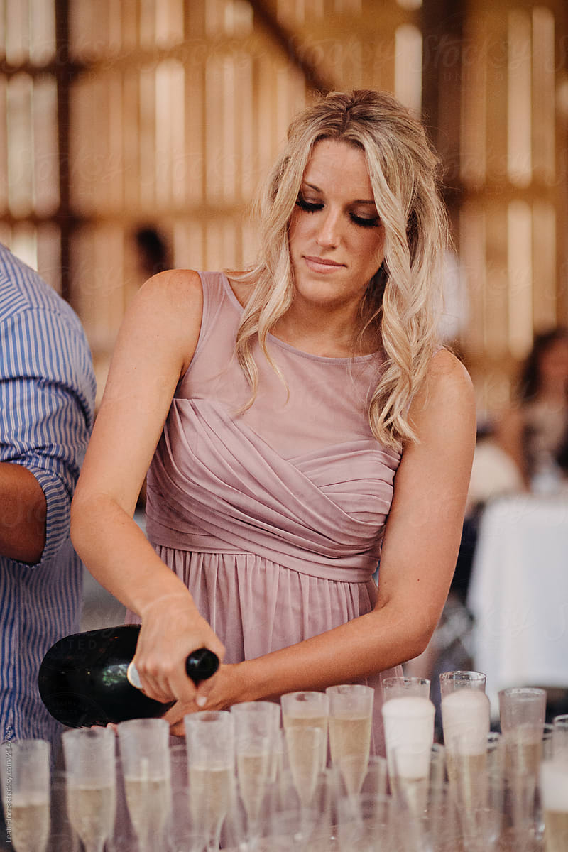 Bridesmaid Pouring Champagne for Wedding Toast