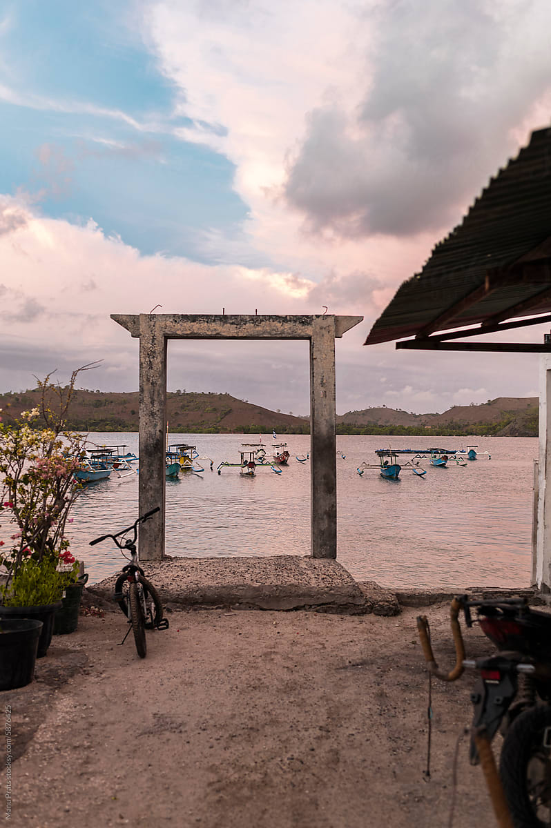 Framed harbor with a concrete doorway at dusk in Indonesia