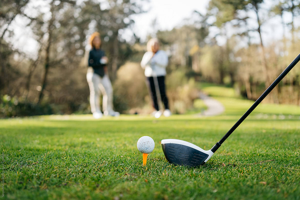 Women playing golf in park