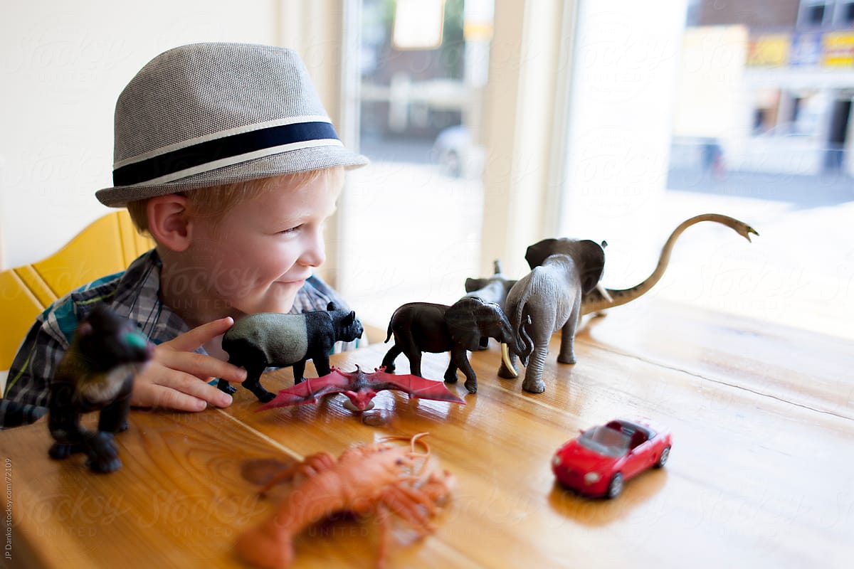 Little Boy Playing with Toys at Coffee Shop