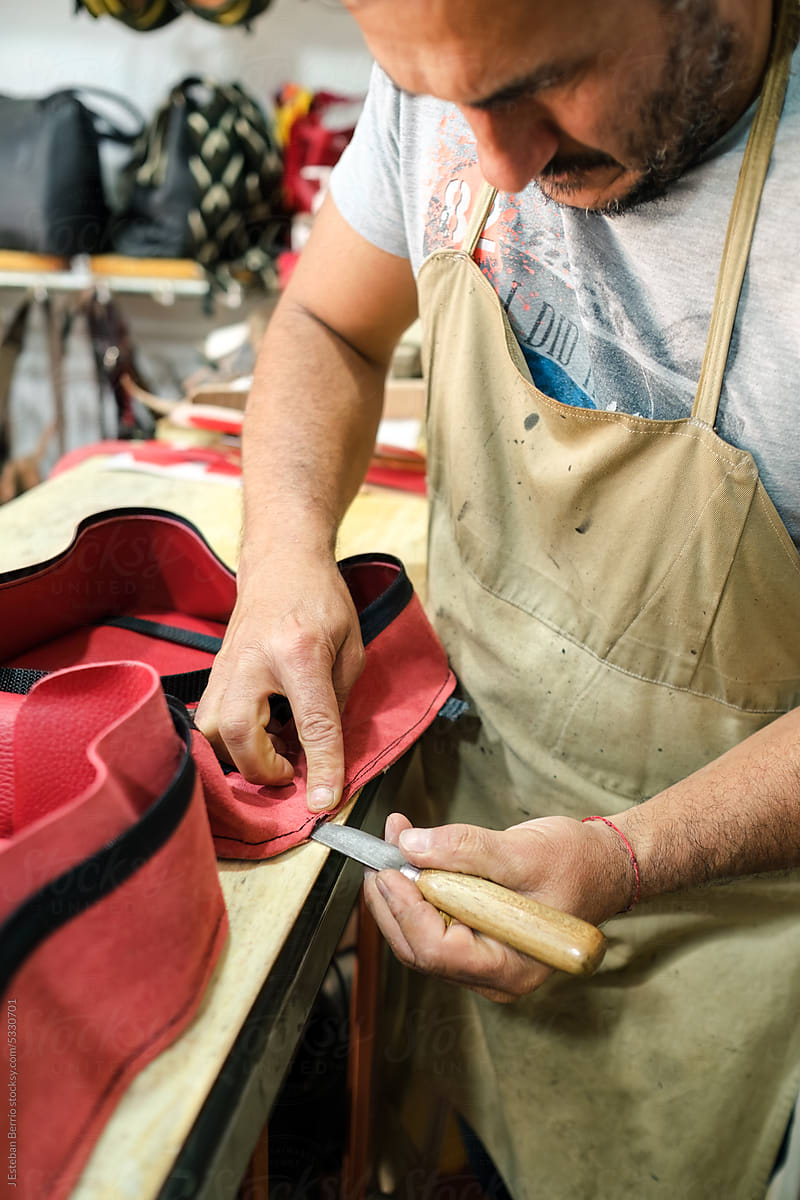 Latin leather worker making a bag