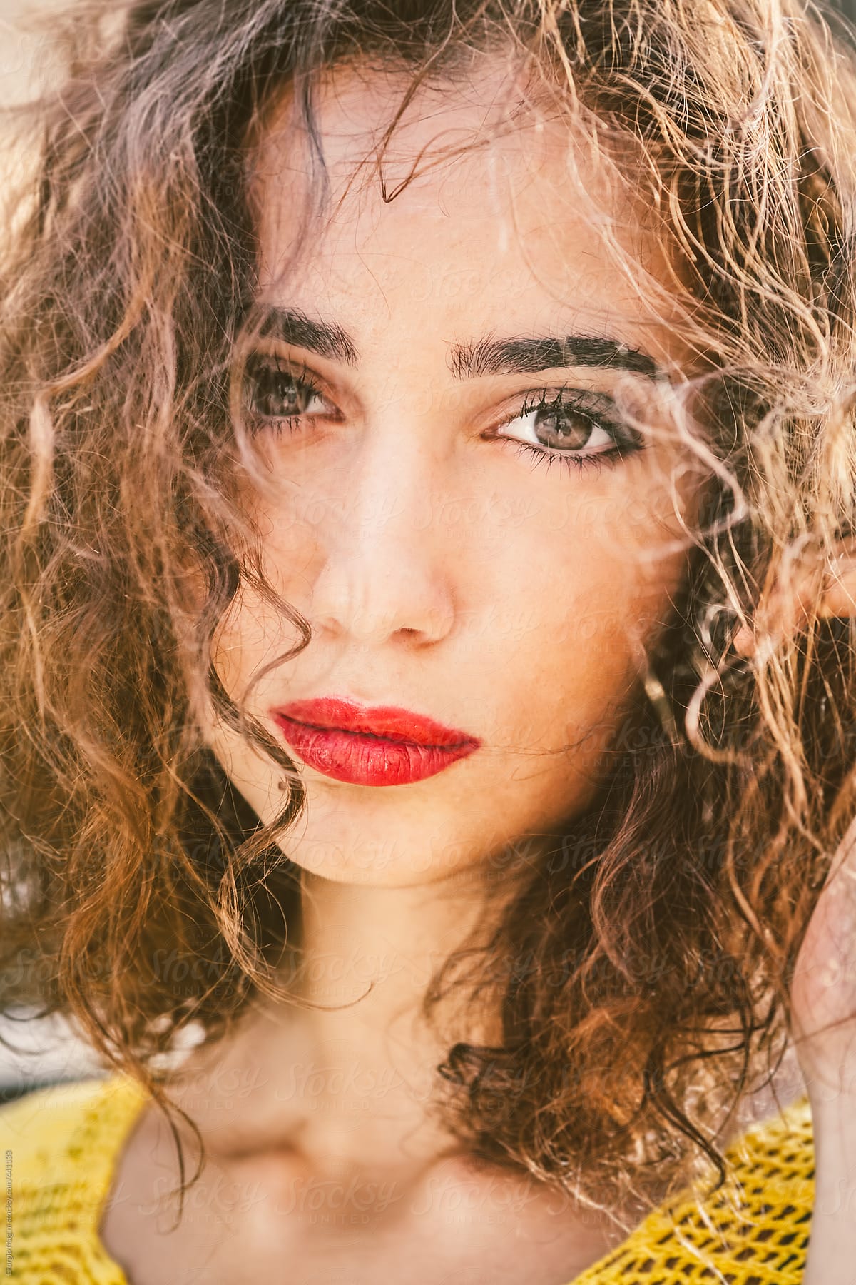 Close Up Portrait of a Beautiful Young Woman with Curly Hair