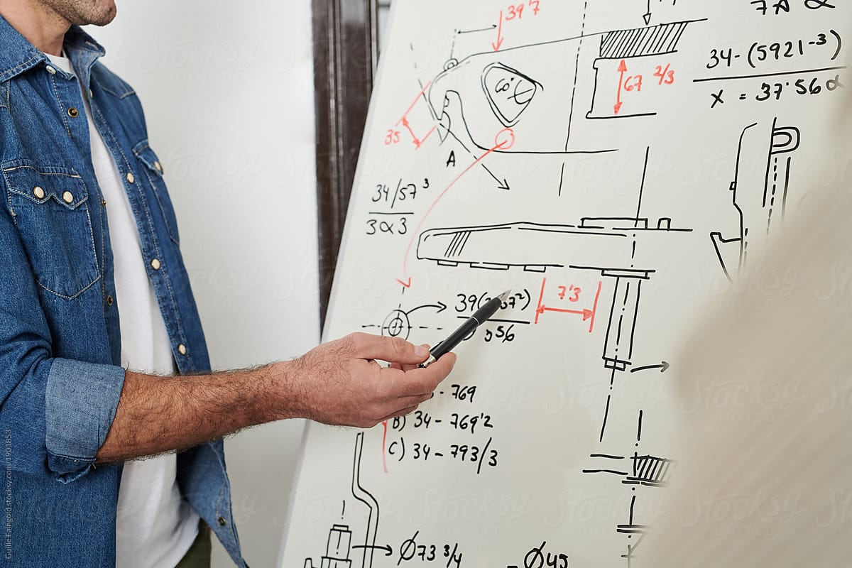 Close-up of engineer pointing at calculations
