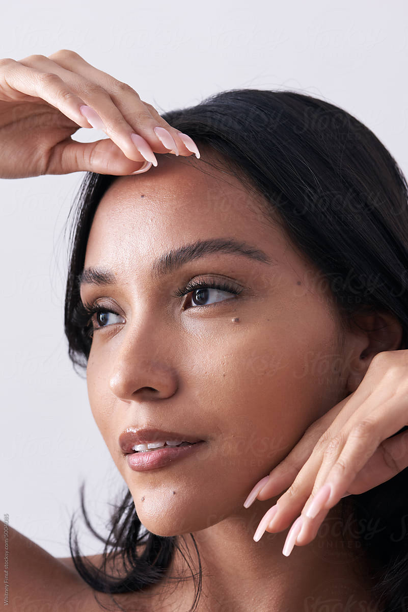 Beauty portrait of Latina woman featuring healthy glowing skin