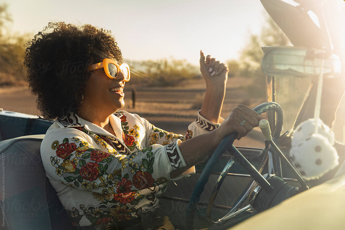 Happy Gorgeous Black woman in Vintage Car on Summer afternoon