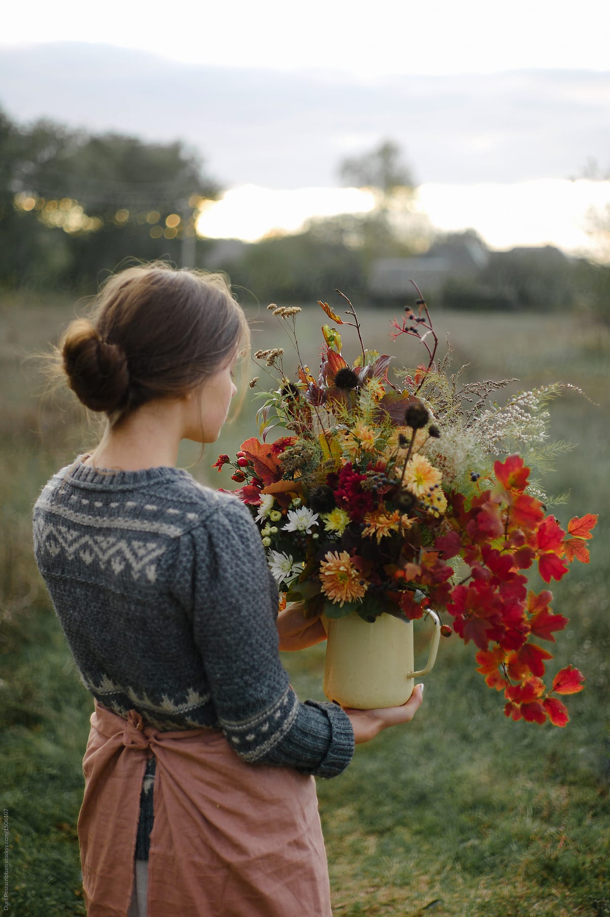 Woman holding bunch of rustic flowers