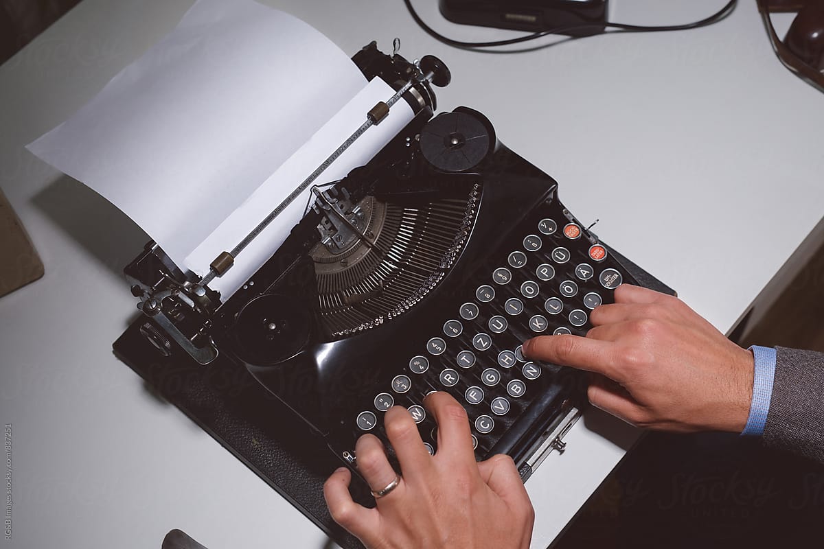Man typing with a vintage typewriter