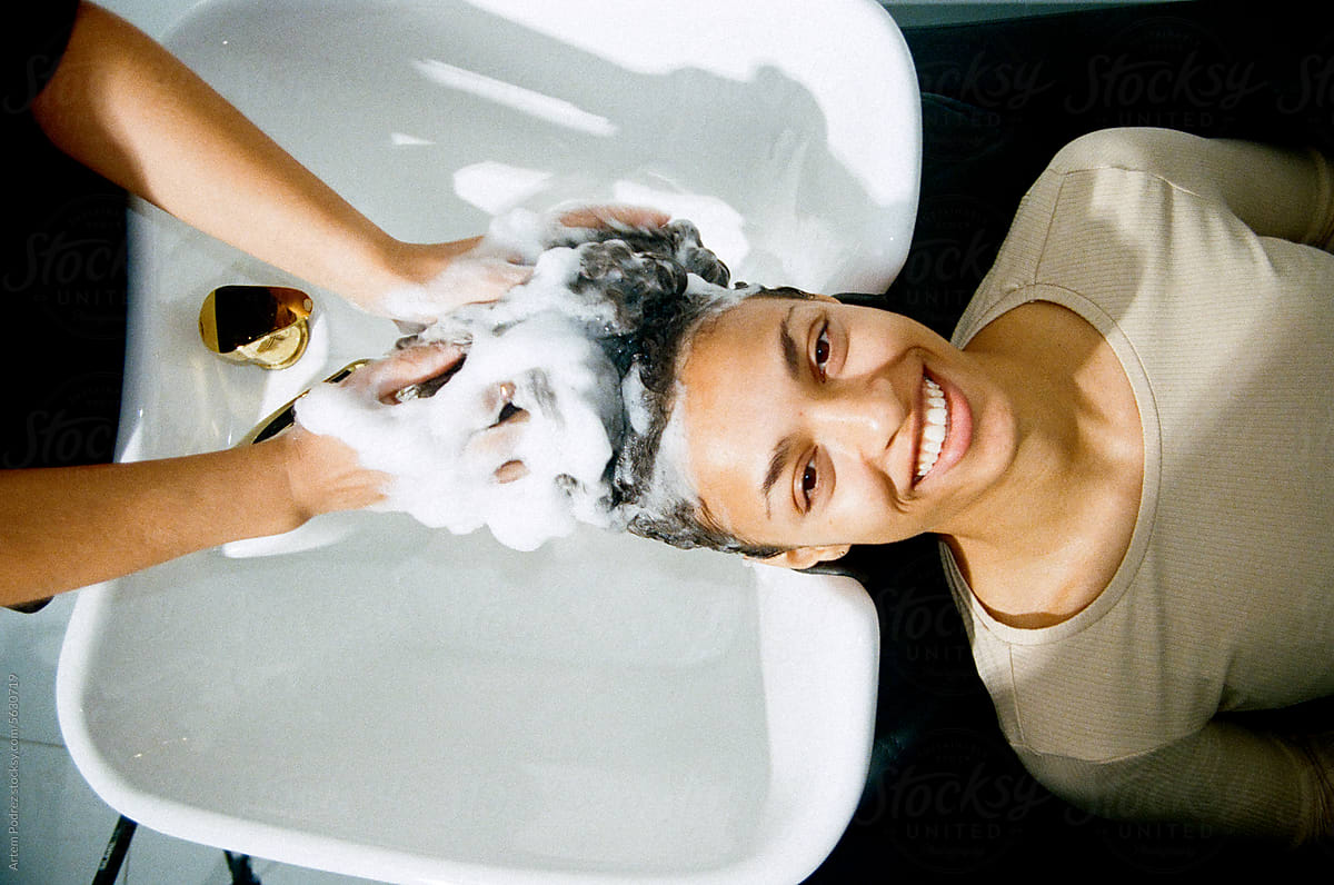 Hairdresser Washing A Woman\'s Hair With Shampoo. Film photo