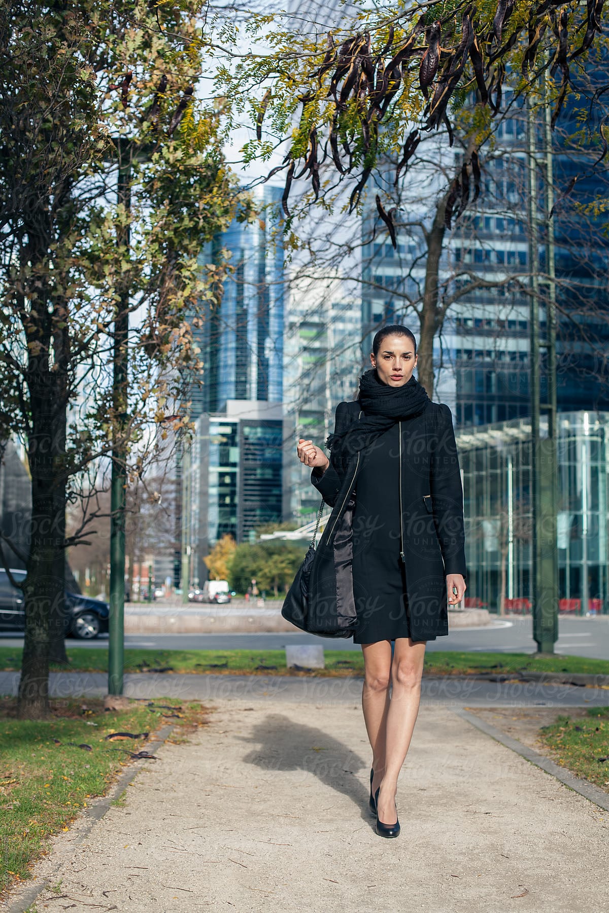 Elegant Woman Walking Down The Street by Stocksy Contributor Mosuno -  Stocksy