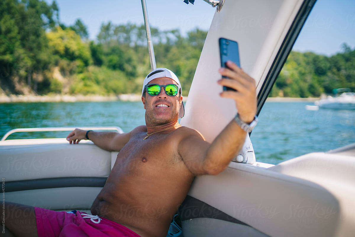 Man taking selfie in boat