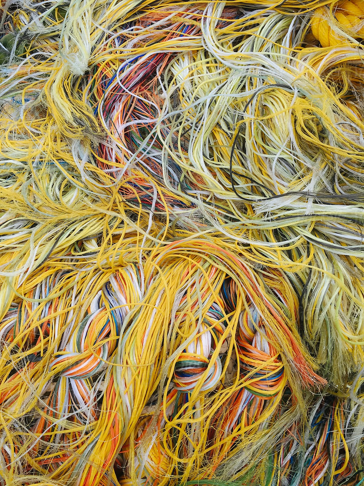 Close Up Of Pile Of Colorful Ropes And Commercial Fishing Nets by Stocksy  Contributor Rialto Images - Stocksy
