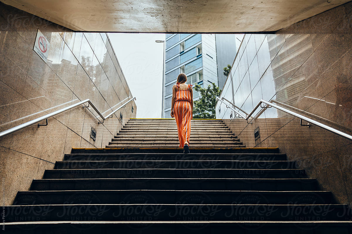 Woman Walking Up The Stairs In The Underpass Horizontal By Stocksy Contributor Andrey Pavlov