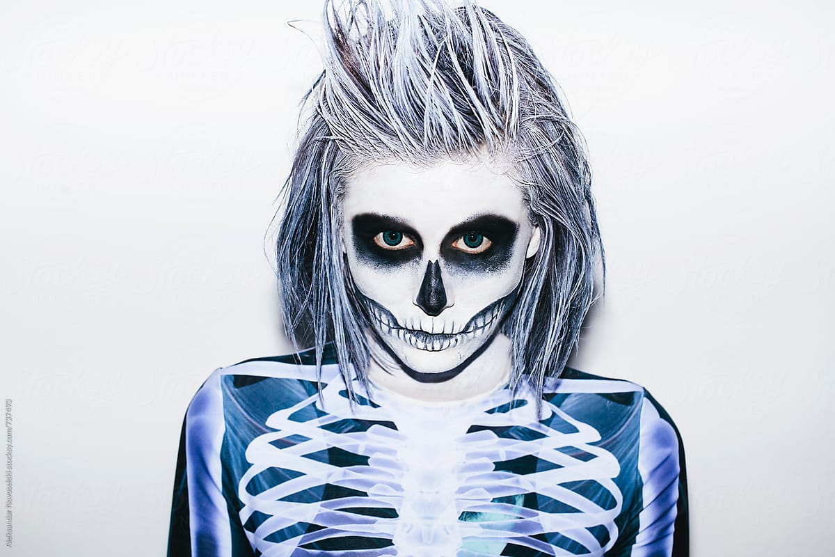 Portrait of a young woman with halloween make up and skeleton costume