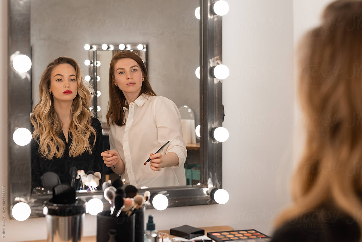 Women admiring makeup in mirror