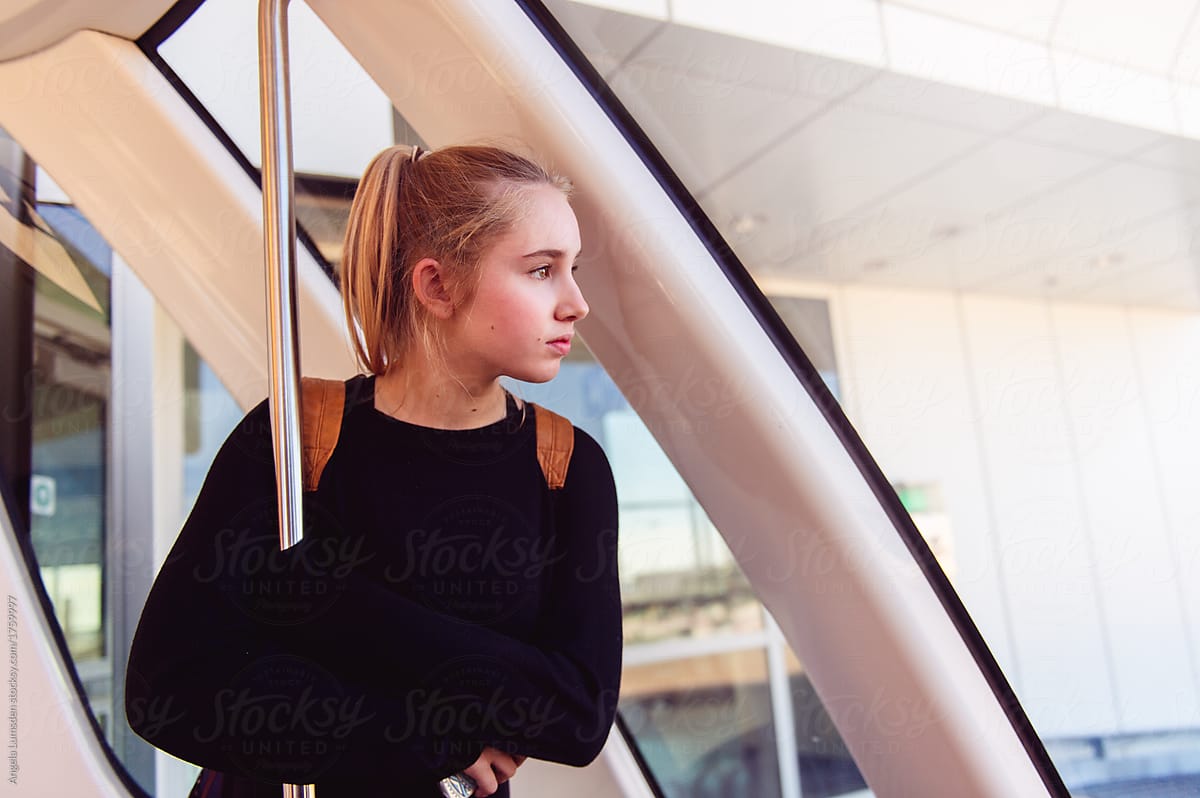 Teenage girl looking out a train window