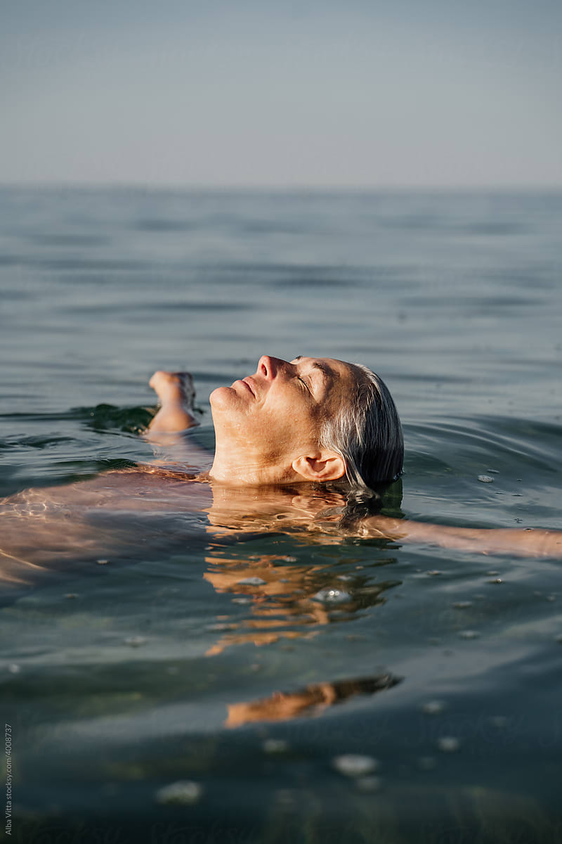 Active Mature Woman Enjoying The Beach In The Morning by Stocksy  Contributor Alba Vitta - Stocksy