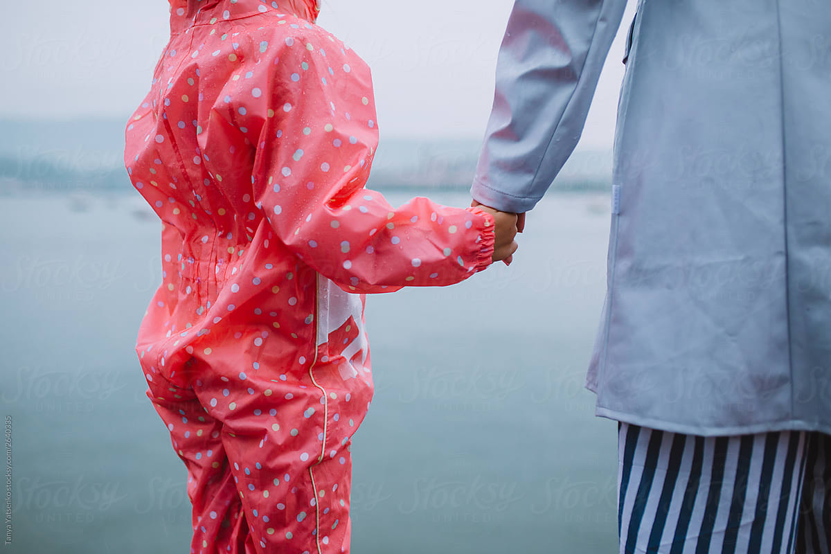 Daughter holding her mother\'s hand near the sea