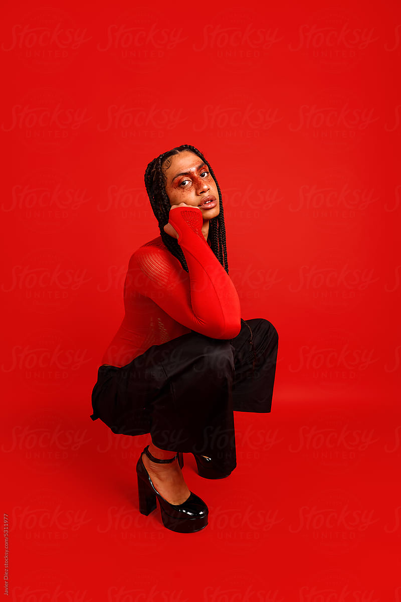 Stylish lady on red backdrop