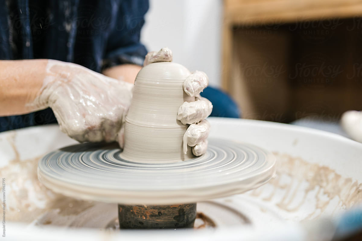 Anonymous hands of a ceramist shaping a piece of clay