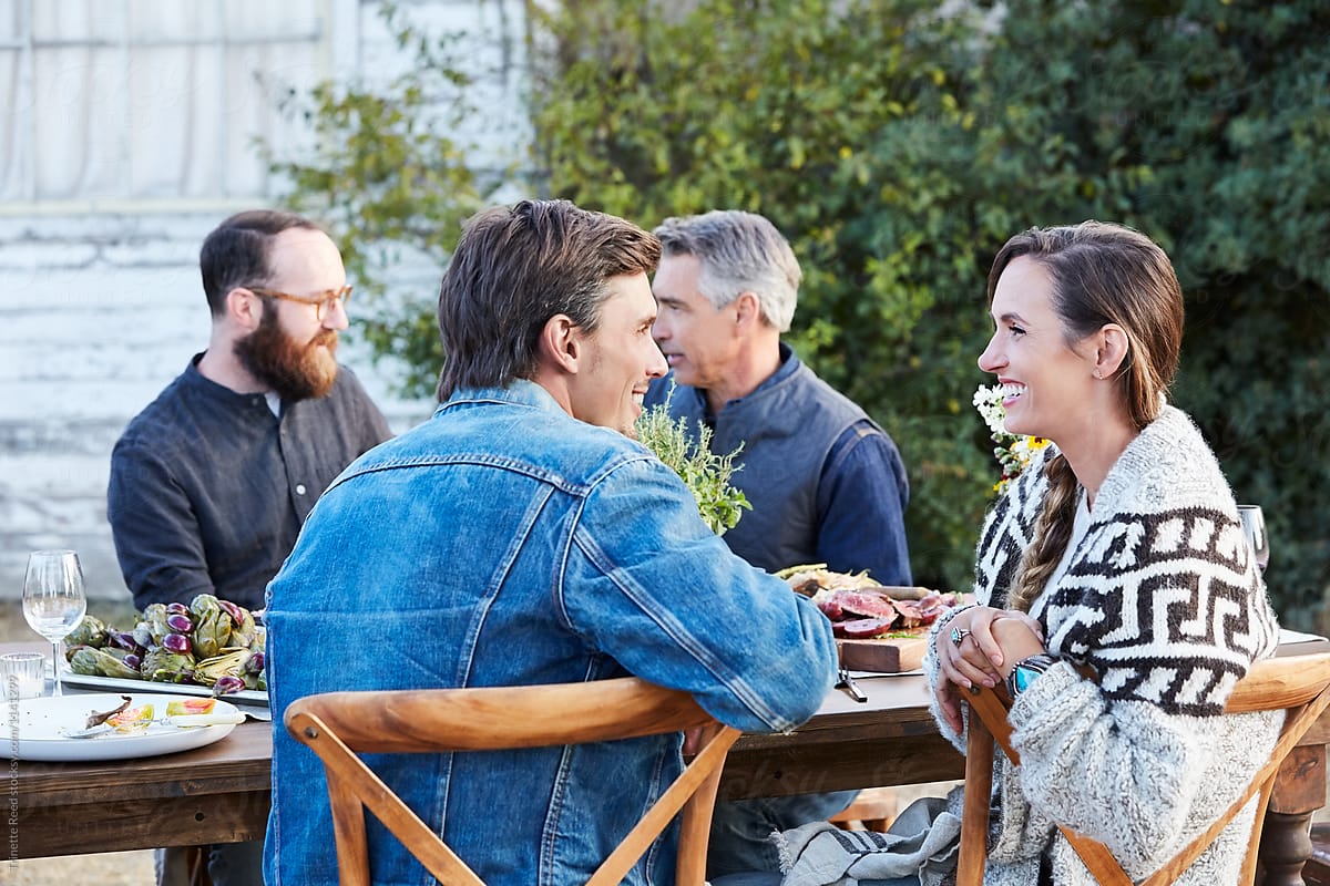 Couple talking at social gathering and outdoor dining
