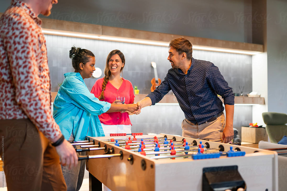 People Playing Table Football Game Indoors