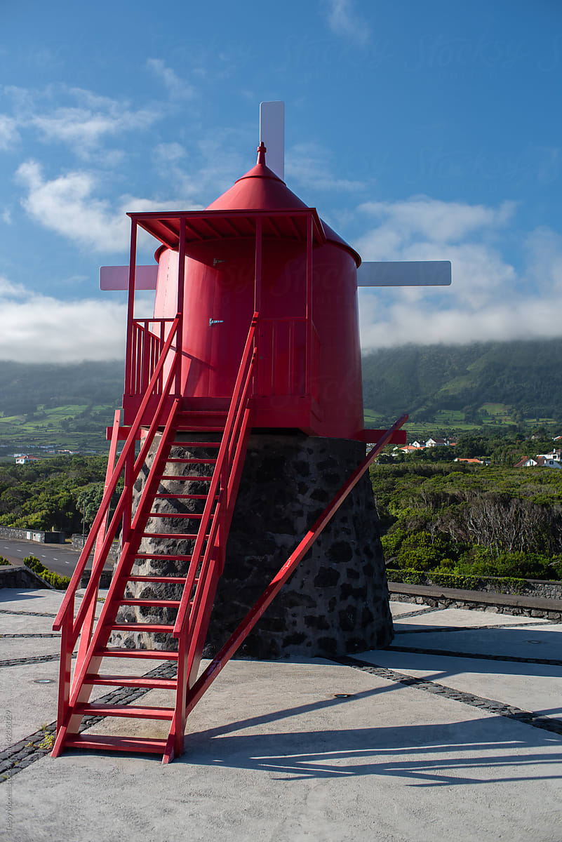 Red windmill on the coastline