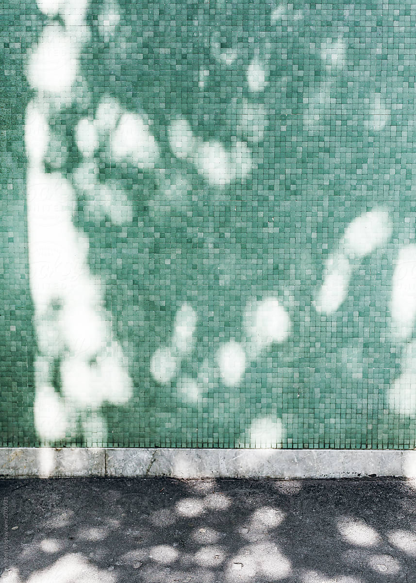A teal mosaic wall roadside in Milan