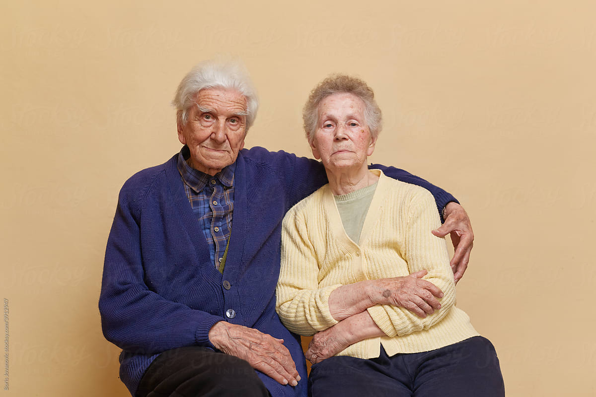 Two Elder People Sitting Close To Each Other