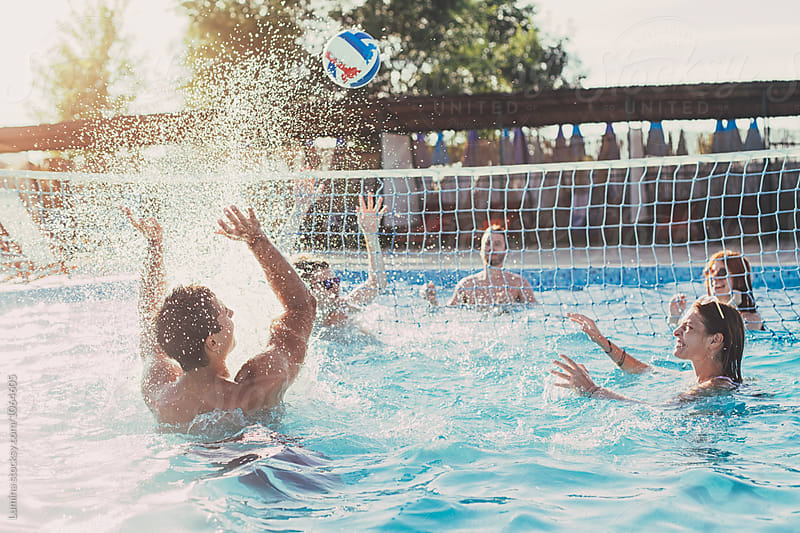 Group of People Playing Volleyball in the Swimming Pool