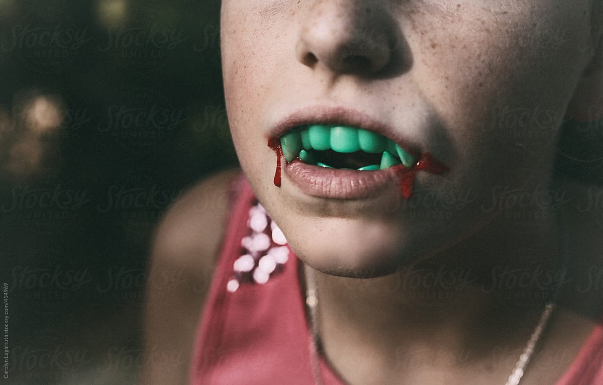 Young girl with fangs and blood for Halloween