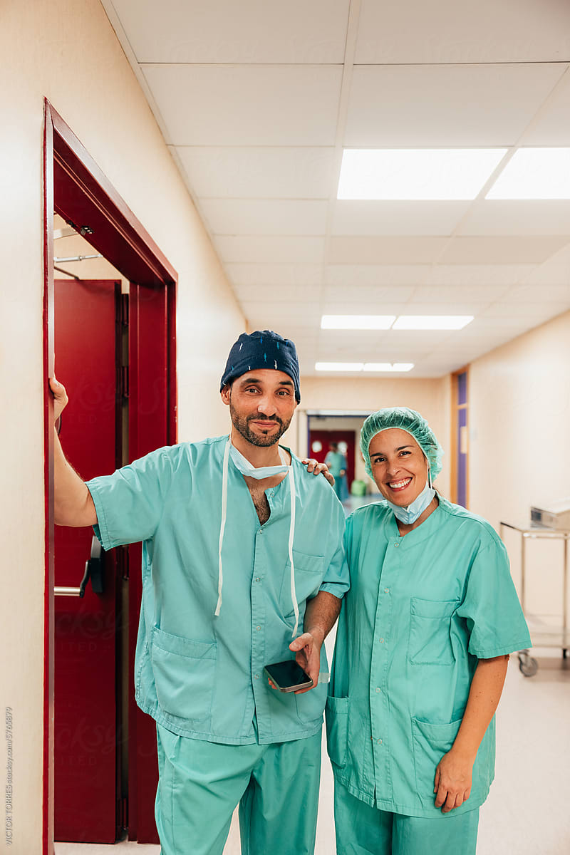 Medical team smiling in hospital corridor