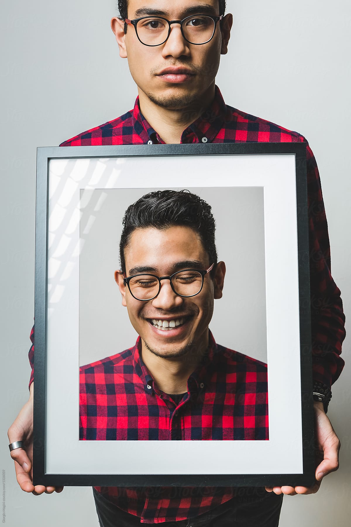 Young Creative Man Showing a Smiling Portrait of Himself