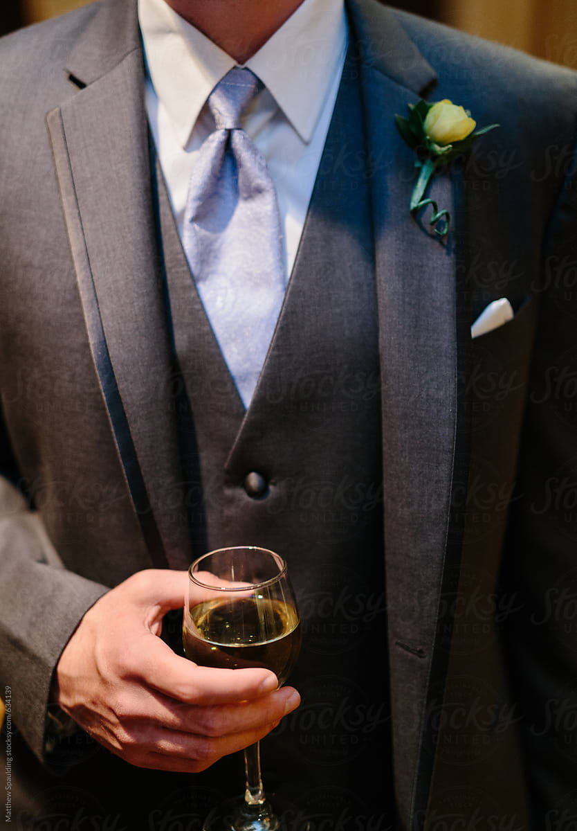 Man In Formal Suit And Tie Holding Wine Glass At Cocktail Party by Stocksy  Contributor Matthew Spaulding - Stocksy