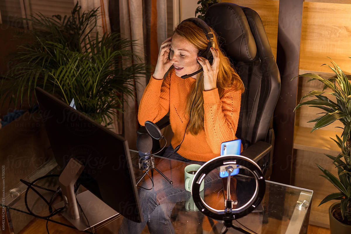 redhead streamer girl putting on her headphones