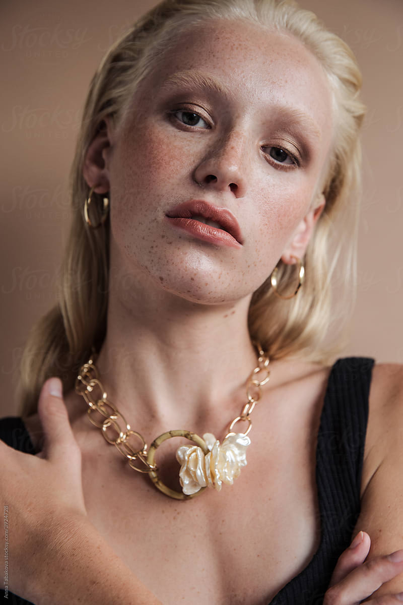 Young model wearing earrings and necklace