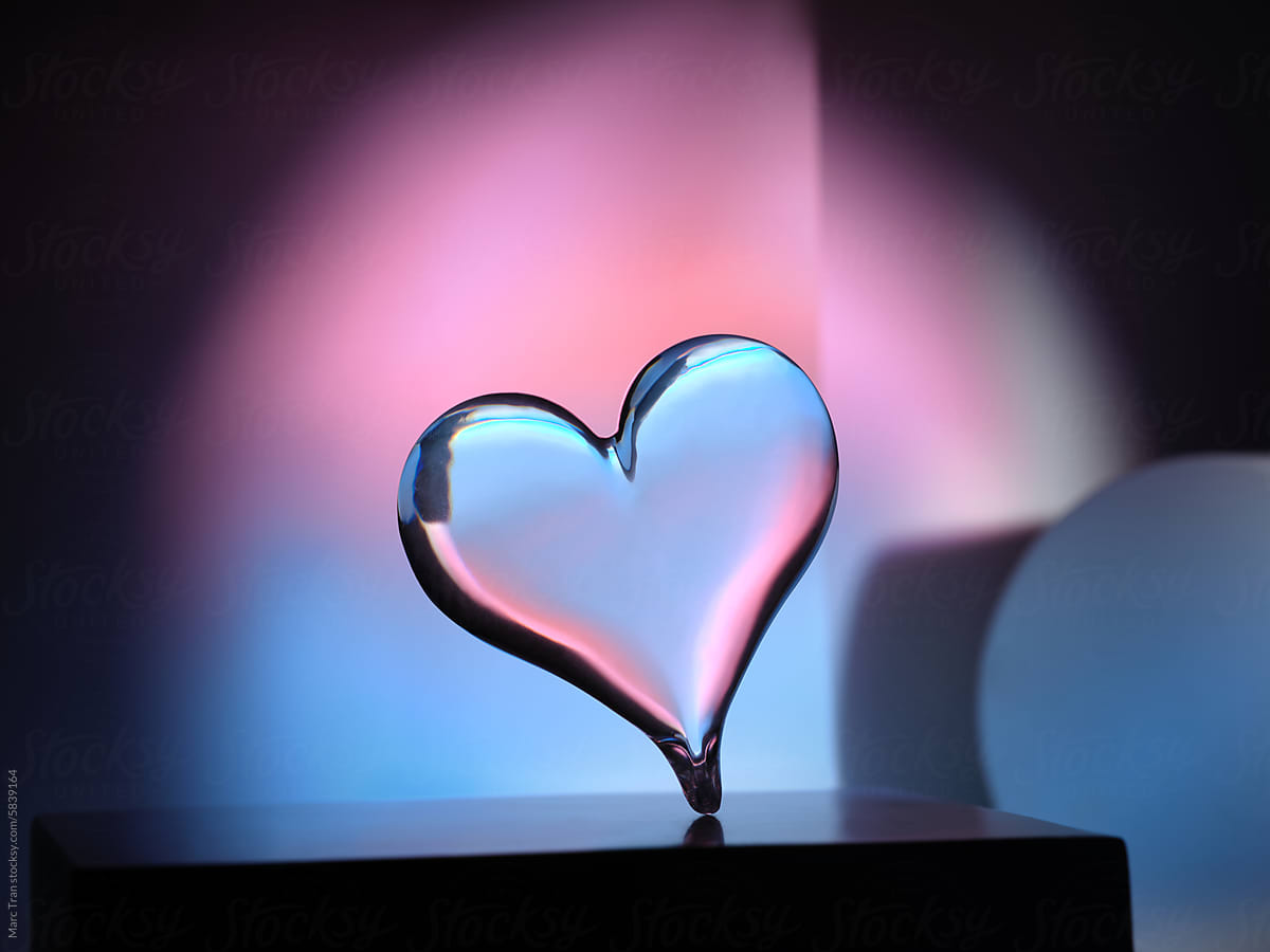 Crystal heart shape floating above an podium against neon light