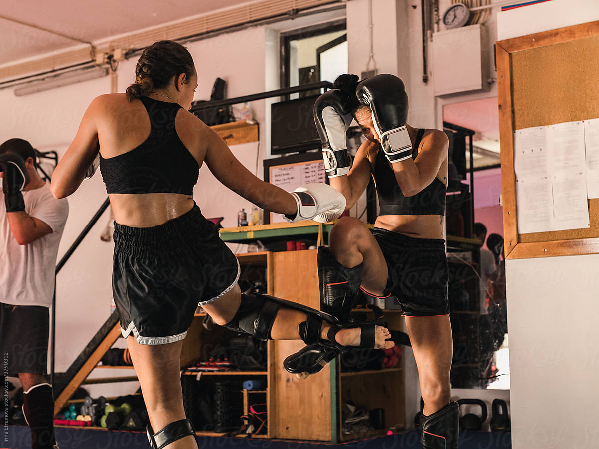 Female Muay Thai Athlete Kicking The Opponent