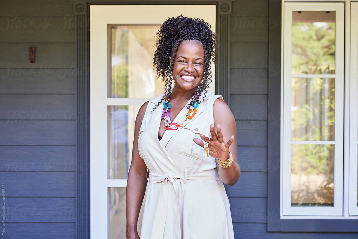 Mature Black woman new home owner holding new house keys