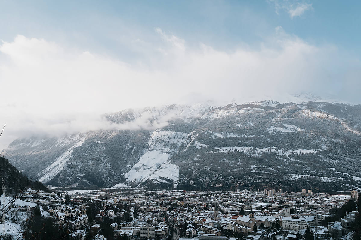 Snowy City Surrounded by Mountains