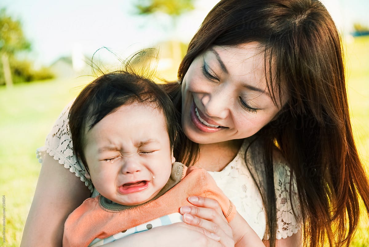 Asian mother\'s love to crying baby