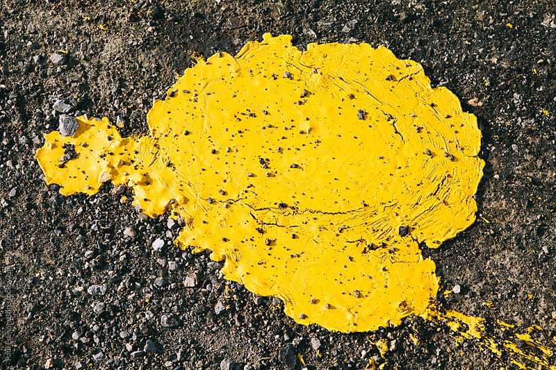 Close up spilled yellow paint used for making road boundaries
