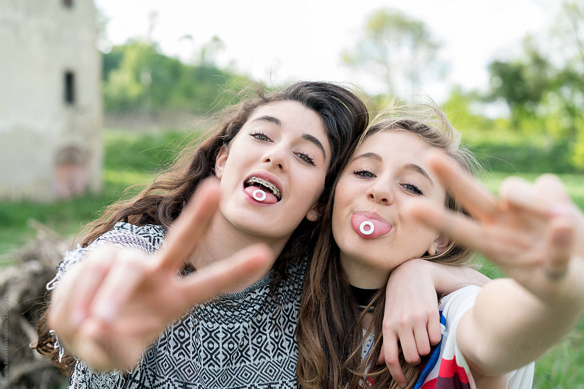 Three Teen Girls Showing Their Tongue To Camera by Stocksy