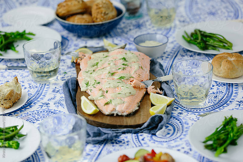 Horizontal wide shot of salmon fillet at dinner party