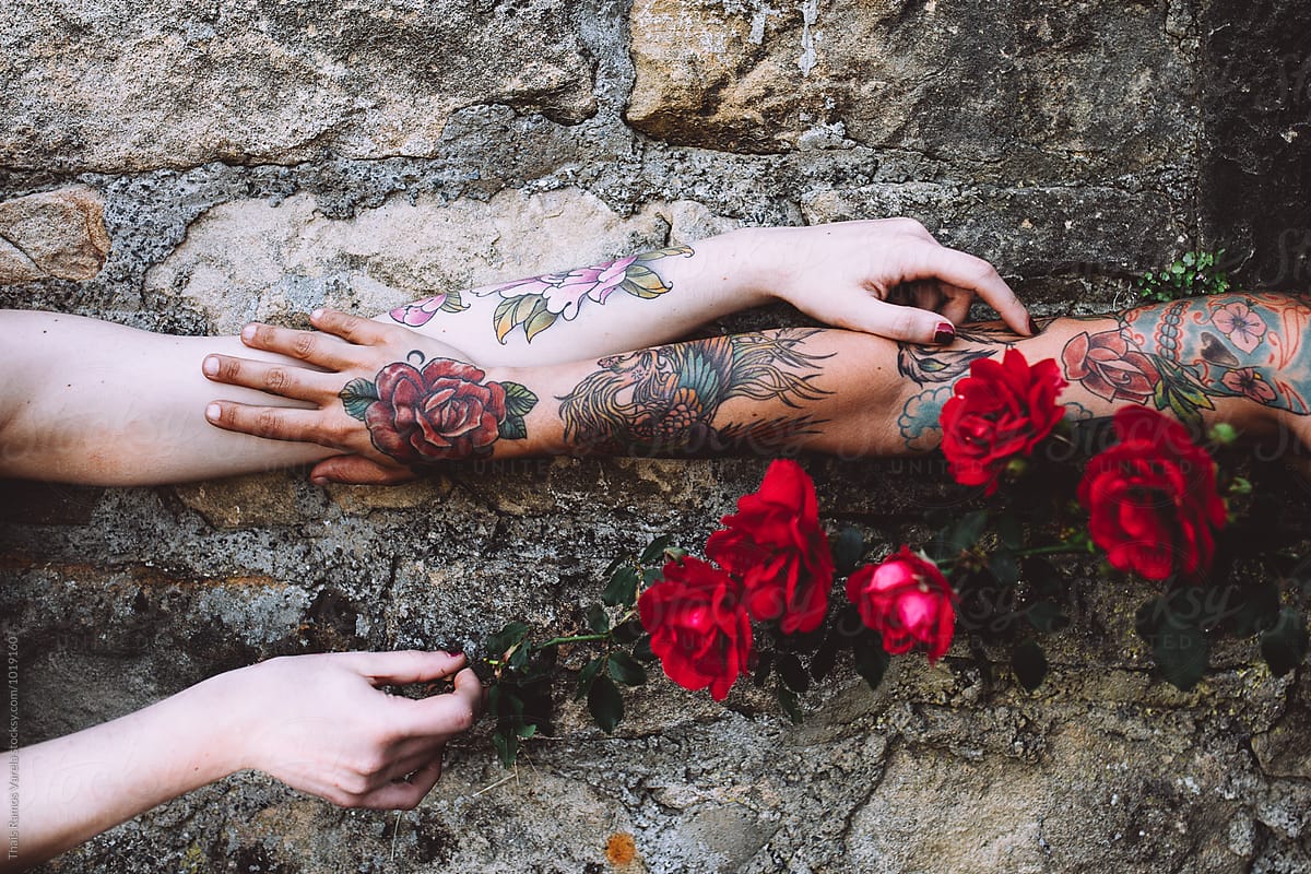 tattooed women holding her hands