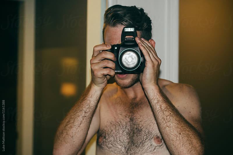 Shirtless Man With Hairy Chest Taking Picture On Camera With Pop