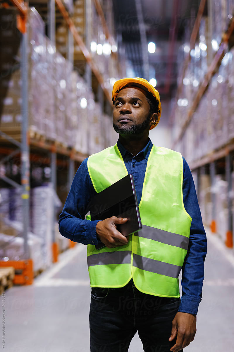 Logistic employee documents standing warehouse