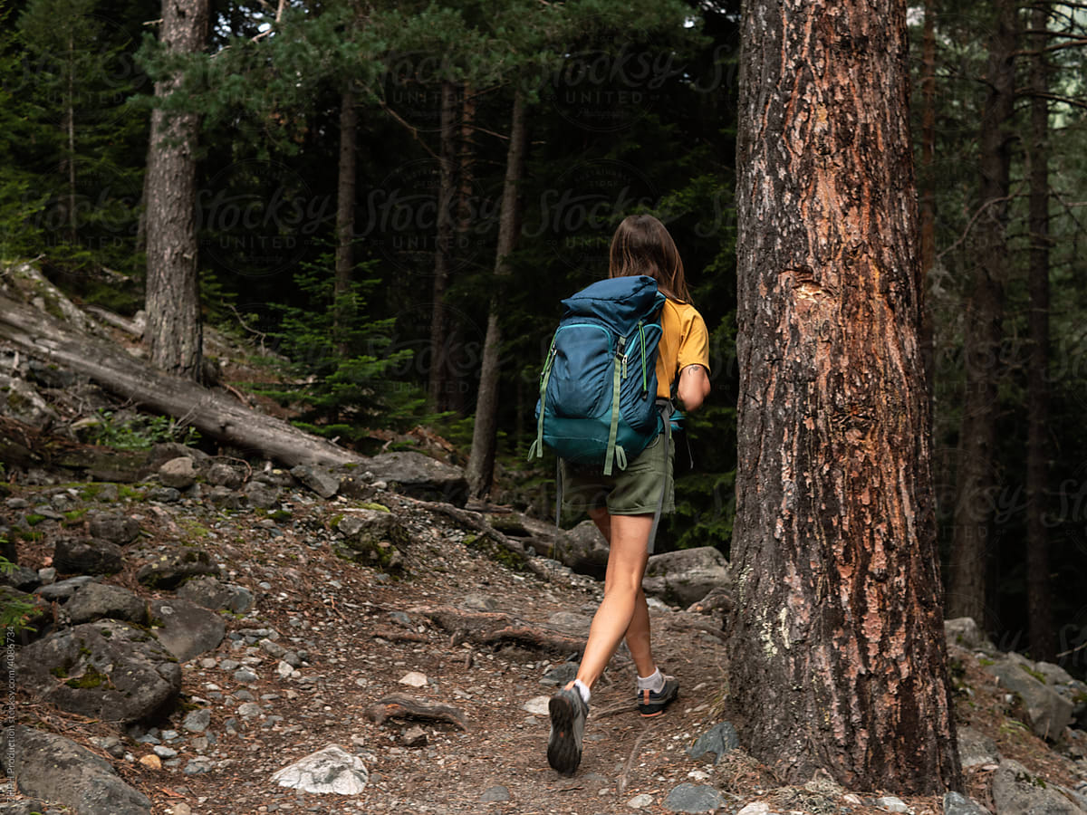 Girl hiking in a dense forest stock photo