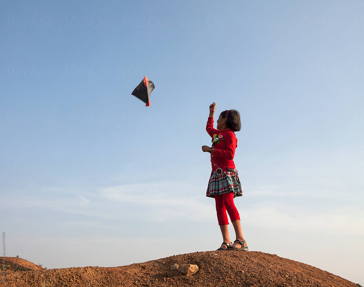 A girl flying kite in rural India