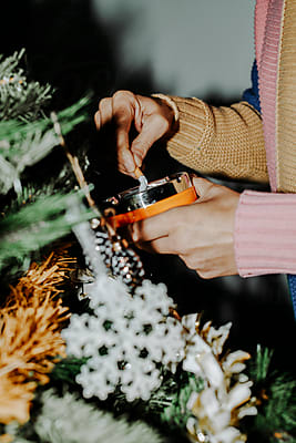 Smoking A Cigarette While Is Decorating The Christmas Tree