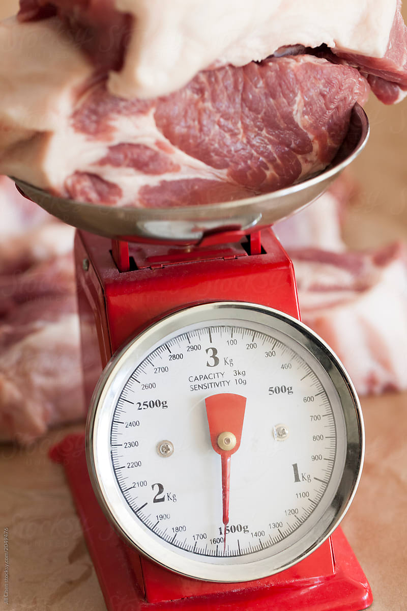 Meat Being Weighed On A Scale by Stocksy Contributor Jill Chen - Stocksy
